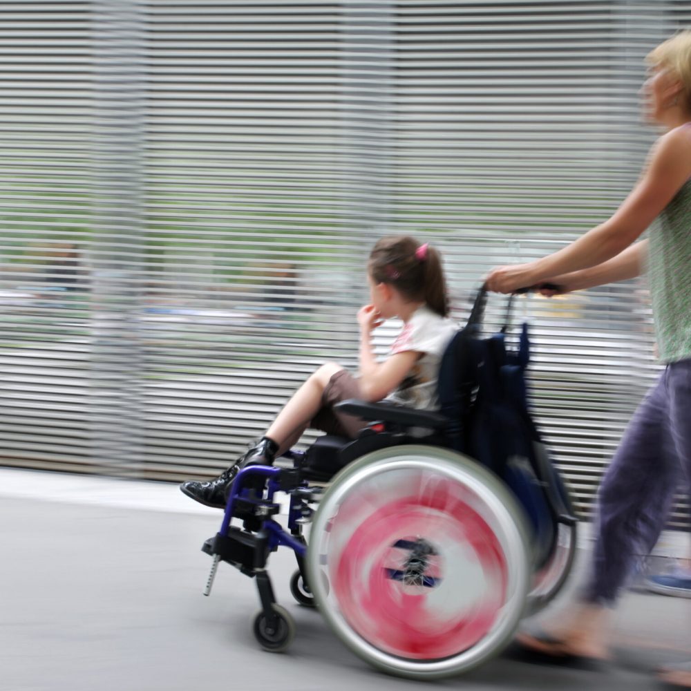 Abstract,Image,Of,Child,With,Disabilities,In,A,Wheelchair,,Accompanied